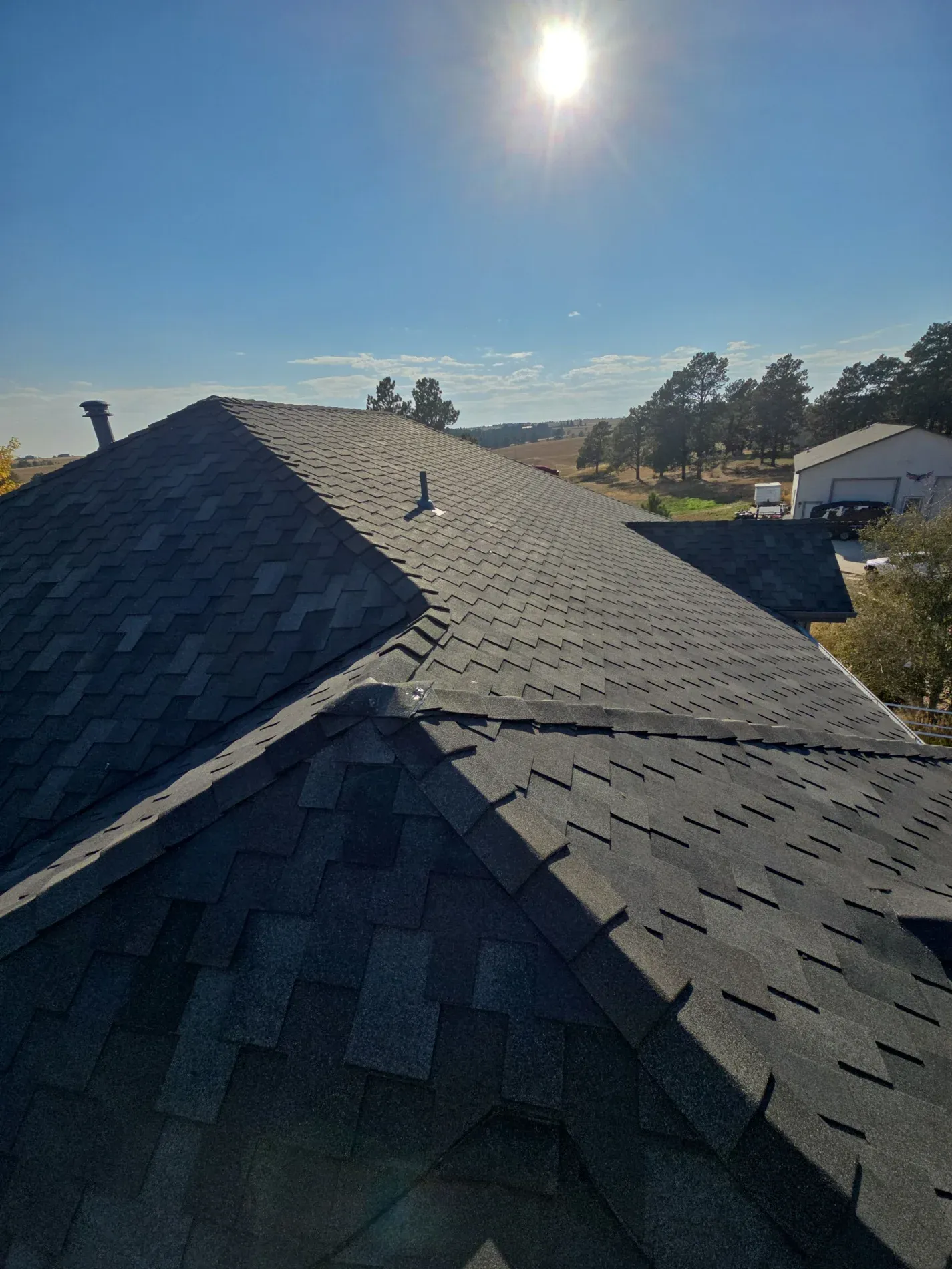 On-roof view of designer shingles with sun