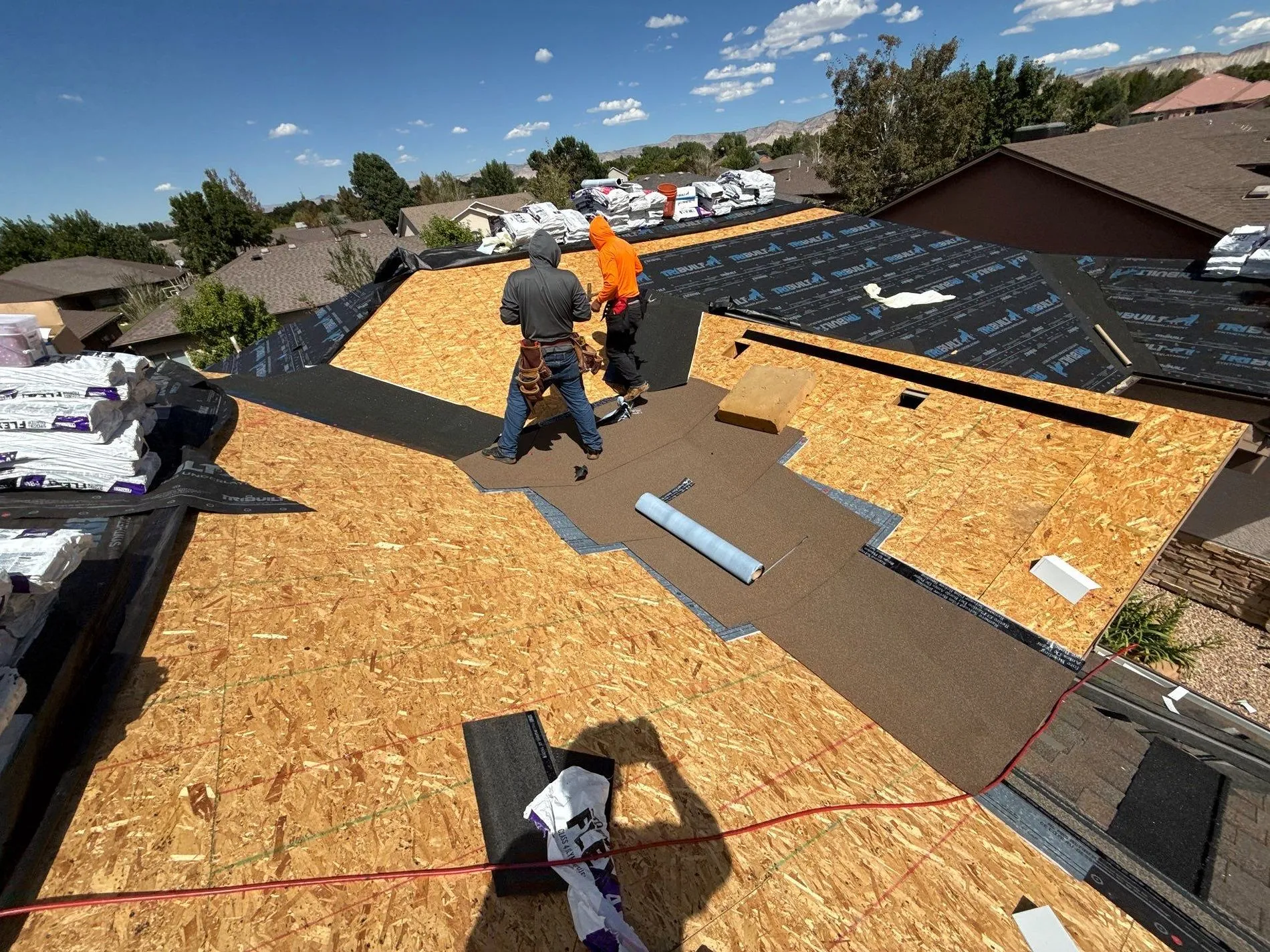 Crew laying underlayment on deck