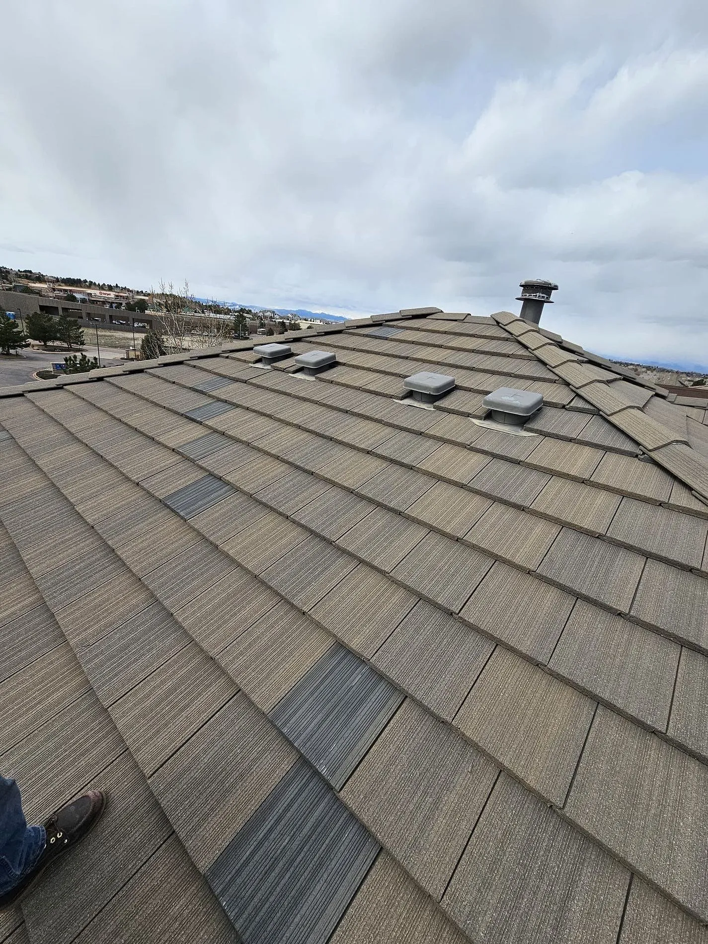 On-roof view of tile installation with skylights