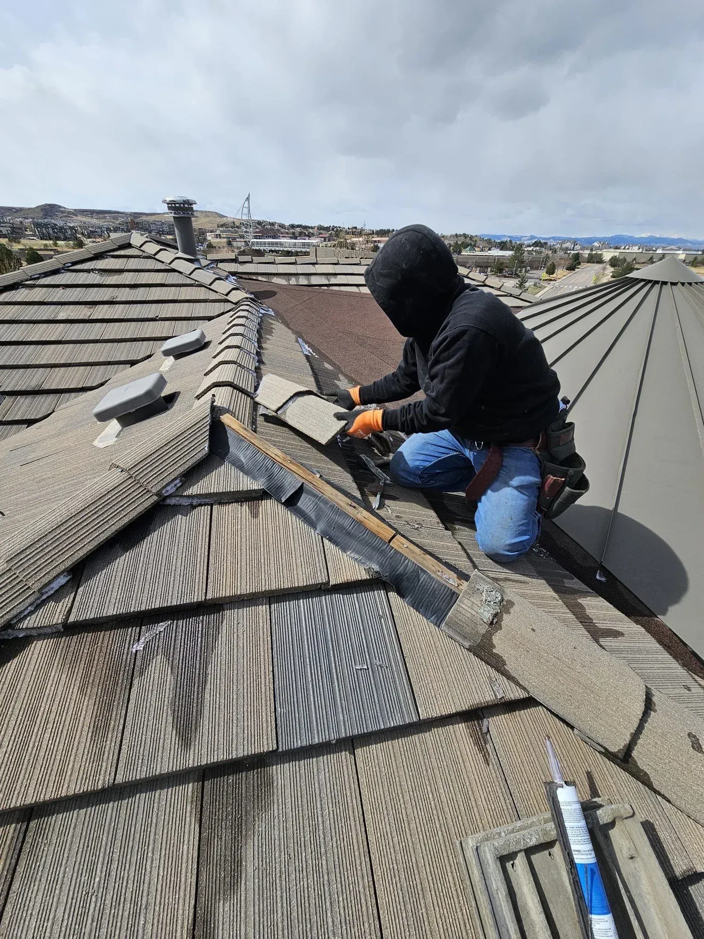 Crew installing tile on ridge